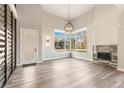 Bright living room with large windows, fireplace, and hardwood floors at 1694 Quitman St, Denver, CO 80204