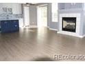 Open-concept living room featuring a cozy fireplace at 7982 S Kittredge Way, Englewood, CO 80112