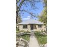 A charming single-story brick home with a well-maintained lawn and walkway to the front door at 3341 Oneida St, Denver, CO 80207
