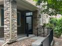 Stylish front porch with stone accents and a black metal railing at 11282 Osage N Cir # F, Northglenn, CO 80234