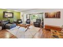 Comfortable living room with a bay window, hardwood floors, and cozy seating furniture at 9325 Utica St, Westminster, CO 80031
