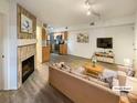 Virtually staged living room with fireplace and open concept kitchen at 1825 Kendall St # 215, Lakewood, CO 80214