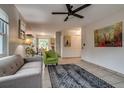 Open-concept living room showcases neutral color palette, tile floors, and seamless flow to dining area at 999 Osceola St, Denver, CO 80204