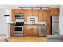 Charming kitchen with stainless steel appliances, wooden cabinets, and granite countertops, offering modern convenience at 1 N Pearl St # 201, Denver, CO 80203