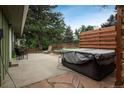 Relaxing backyard patio with hot tub, seating, stone and concrete features at 11805 W 74Th Ave, Arvada, CO 80005