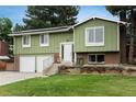 Home with brick accents, mature trees, a well-maintained lawn, and charming details at 11805 W 74Th Ave, Arvada, CO 80005