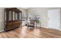 Bright living room with wood flooring, a chair, large wooden china cabinet, and plenty of natural light at 9407 W Gibraltar Pl, Littleton, CO 80127