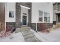 Inviting front entrance with blue door, stone accents, and a charming wreath at 1933 W 165Th Way, Broomfield, CO 80023