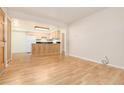Spacious living room showcasing hardwood floors, with an open layout to the kitchen area at 5995 W Hampden Ave # 3E, Denver, CO 80227