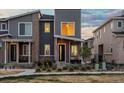 Charming two-story townhome with modern gray siding and brick accents at 24333 E 41St Ave, Aurora, CO 80019