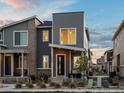 Charming two-story townhome with modern gray siding and brick accents at 24333 E 41St Ave, Aurora, CO 80019