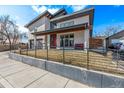 Attractive modern home showcasing a covered front porch, gray garage, and sleek architectural details at 745 S Eliot St, Denver, CO 80219