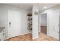 Hallway view features white door, open shelving and easy access to rooms at 12281 E Tennessee Dr # 303, Aurora, CO 80012