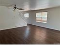 Open living room featuring hardwood floors, staircase and plenty of natural light at 897 Mockingbird Ln, Brighton, CO 80601