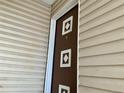 Close up of an apartment door featuring a dark wooden door with white framed diamond accents at 14172 E Colorado Dr # 204, Aurora, CO 80012