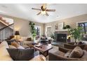 Cozy living room featuring a fireplace, comfortable seating, and large windows providing ample natural light at 17015 Oxbridge Rd, Monument, CO 80132