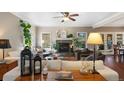 Cozy living room showcases a fireplace, plush sofa, and a tranquil view of the backyard at 17015 Oxbridge Rd, Monument, CO 80132