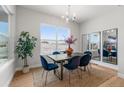 Dining room featuring stylish decor, a large window with backyard views and a modern light fixture at 890 Coal Bank Trl, Castle Rock, CO 80104