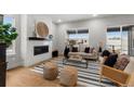 Bright living room features a modern fireplace, large windows and an open layout at 890 Coal Bank Trl, Castle Rock, CO 80104
