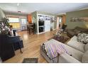 Open-concept living room with hardwood floors, cozy seating, and a piano; great for entertaining at 1245 S Forest St, Denver, CO 80246