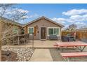 Charming home with a covered front porch and an inviting outdoor seating area, perfect for relaxation at 235 N 7Th Ave, Brighton, CO 80601