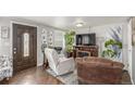 Cozy living room featuring hardwood floors, neutral paint, modern furnishings, and decor at 235 N 7Th Ave, Brighton, CO 80601