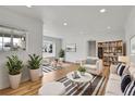 Bright living room featuring hardwood floors, recessed lighting, and stylish furniture creating an inviting space for relaxation at 3001 Fairfax St, Denver, CO 80207