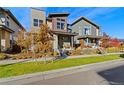 Two story home with light-colored siding and a neatly landscaped yard at 5671 N Emporia St, Denver, CO 80239