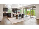 Open-concept dining area with modern chandelier, seamlessly flowing into a state-of-the-art kitchen at 2130 S Poppy St, Lakewood, CO 80228