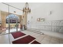 Well-lit lobby featuring tiled floors, a chandelier, mailboxes, seating, and access to the outdoors at 7801 W 35Th Ave # 405, Wheat Ridge, CO 80033