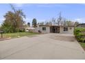 Well-maintained single-story home featuring a spacious driveway and beautifully landscaped front yard at 7160 W 24Th Ave, Lakewood, CO 80214