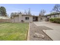 Charming single-story home with a well-maintained lawn and lovely landscaping at 7160 W 24Th Ave, Lakewood, CO 80214