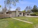 Well-maintained single-story home featuring a lush, green lawn and fenced yard at 7160 W 24Th Ave, Lakewood, CO 80214