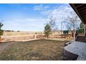 Spacious backyard with a fence, a well-kept grassy area, and a view of an expansive field at 21093 E Hampden Pl, Aurora, CO 80013
