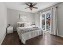 Bright bedroom with sliding glass doors, ceiling fan, and hardwood floors at 17616 Ponderosa Ave, Parker, CO 80134