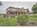 Lovely two-story brick home with a well-maintained lawn and mature landscaping at 7400 S Genoa Cir, Centennial, CO 80016