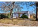 Charming single-story home boasts mature trees, manicured landscaping, and a inviting front porch at 1770 S Yuma St, Denver, CO 80223