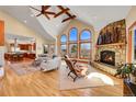 Bright living room boasting hardwood floors, a stone fireplace, large windows, and an open floor plan at 4337 W Hinsdale Ave, Littleton, CO 80128