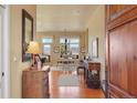 Open foyer showcasing hardwood floors, high ceilings, a mirror, and dining room access with mountain views at 3441 Medallion Rd, Castle Rock, CO 80104