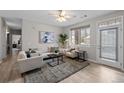 Bright living room featuring stylish furniture, decor, and lots of natural light at 10437 W Hampden Ave # 104, Lakewood, CO 80227