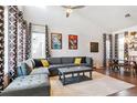 Spacious living room featuring a sectional sofa and large windows at 5731 Boston Ct, Denver, CO 80238