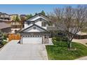 Charming two-story home featuring a spacious two car garage, landscaped front yard and inviting entrance at 13972 Hudson Way, Thornton, CO 80602