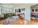 Cozy living room with hardwood floors, a comfortable sofa, and a stylish entertainment center at 1135 Orion St, Golden, CO 80401