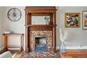 Ornate, decorative fireplace with brick and wood surround adds character and charm to the home at 315 E Bayaud Ave, Denver, CO 80209
