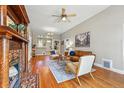Cozy living room with a decorative fireplace, hardwood floors, and comfortable seating area at 315 E Bayaud Ave, Denver, CO 80209