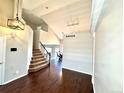 Bright foyer with hardwood floors, high ceilings, and a staircase leading to the upper level at 18997 E Crestridge Cir, Aurora, CO 80015