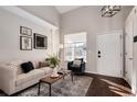 Bright living room with vaulted ceiling, neutral decor, and hardwood floors at 18997 E Crestridge Cir, Aurora, CO 80015