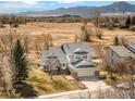 Scenic aerial view of the home with mountains in the background showcasing the property's serene and expansive setting at 4547 Tally Ho Trl, Boulder, CO 80301