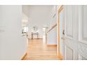 Bright foyer with hardwood floors and elegant staircase, creating a welcoming entrance at 4547 Tally Ho Trl, Boulder, CO 80301