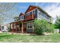 Attractive home featuring a balcony, a covered front porch, and mature landscaping at 900 Wilshire Dr, Berthoud, CO 80513